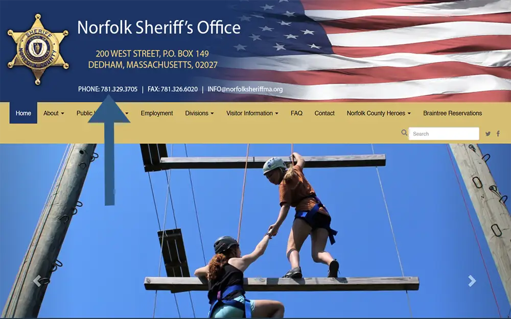 A screenshot from Norfolk County sheriff's office website's homepage showing an arrow pointing at the phone number.